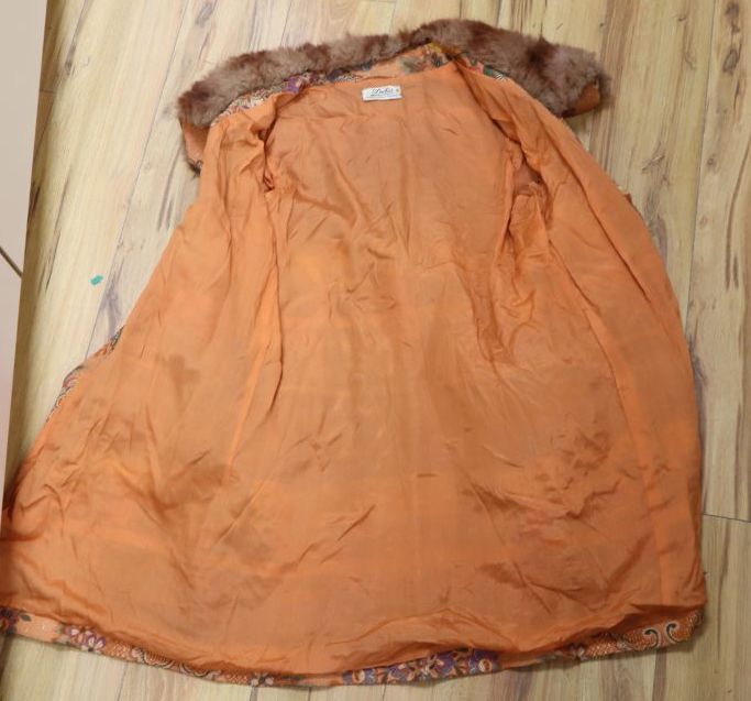 A 1930s orange brocade floral fur trimmed coat label Delia, 99 New Bond Street
